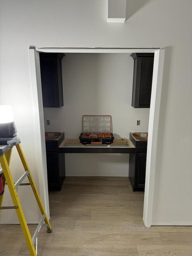 kitchen featuring light hardwood / wood-style flooring and built in desk