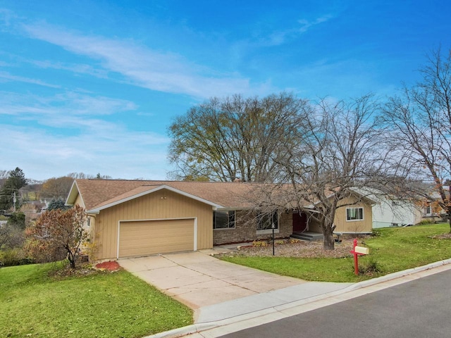 ranch-style home featuring a front lawn and a garage