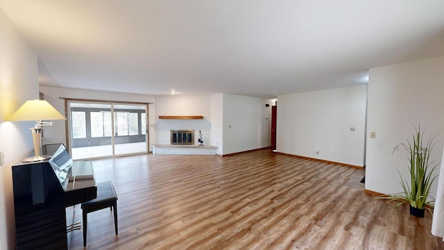 living room with light hardwood / wood-style floors and a fireplace