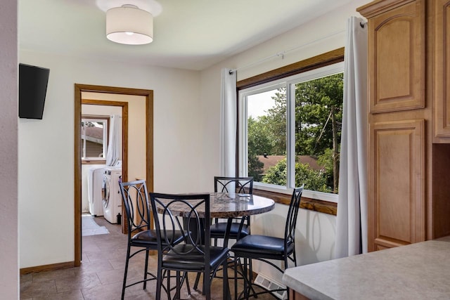 dining space with separate washer and dryer