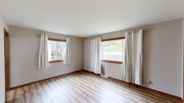 spare room with light wood-type flooring