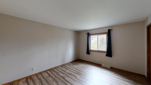 unfurnished room featuring light hardwood / wood-style flooring