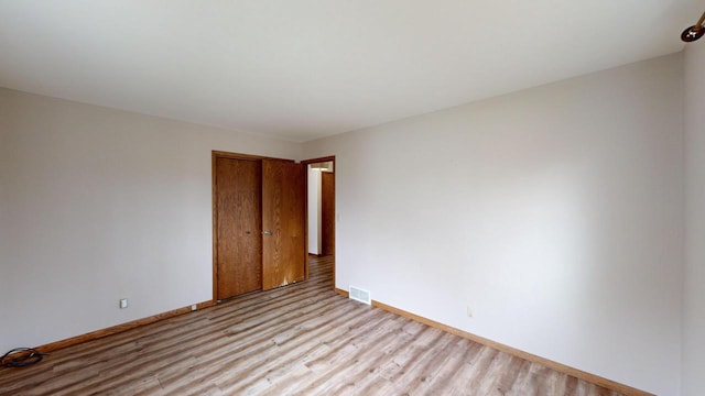 unfurnished room with light hardwood / wood-style floors