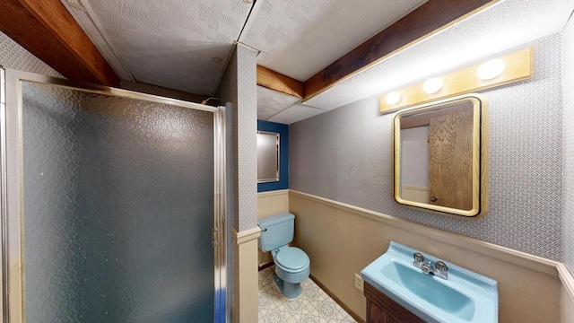 bathroom with a textured ceiling, vanity, an enclosed shower, and toilet