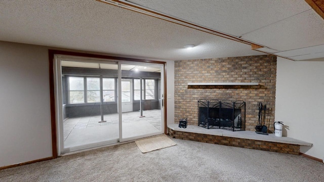 unfurnished living room featuring carpet flooring, a textured ceiling, and a brick fireplace