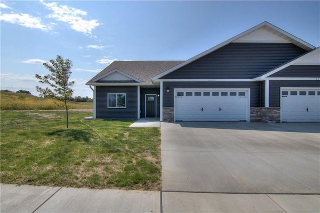 view of front of home with a front lawn and a garage