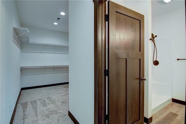 corridor with light hardwood / wood-style floors