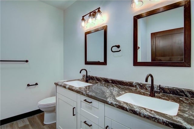 bathroom featuring hardwood / wood-style floors, vanity, and toilet