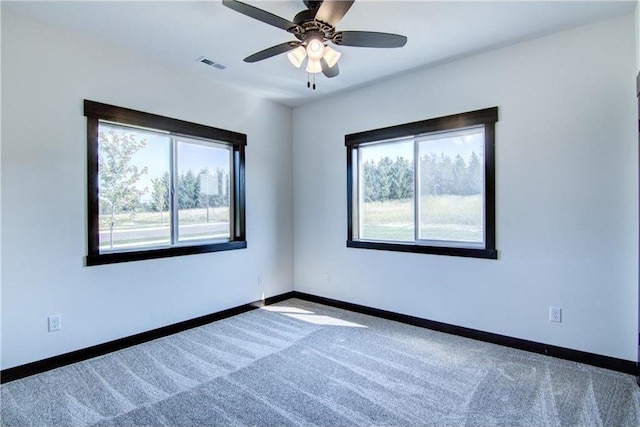 spare room with carpet, ceiling fan, and a wealth of natural light