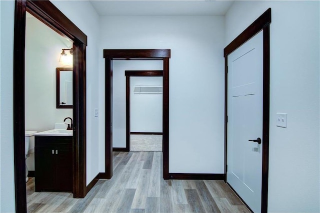 hall featuring sink and light wood-type flooring