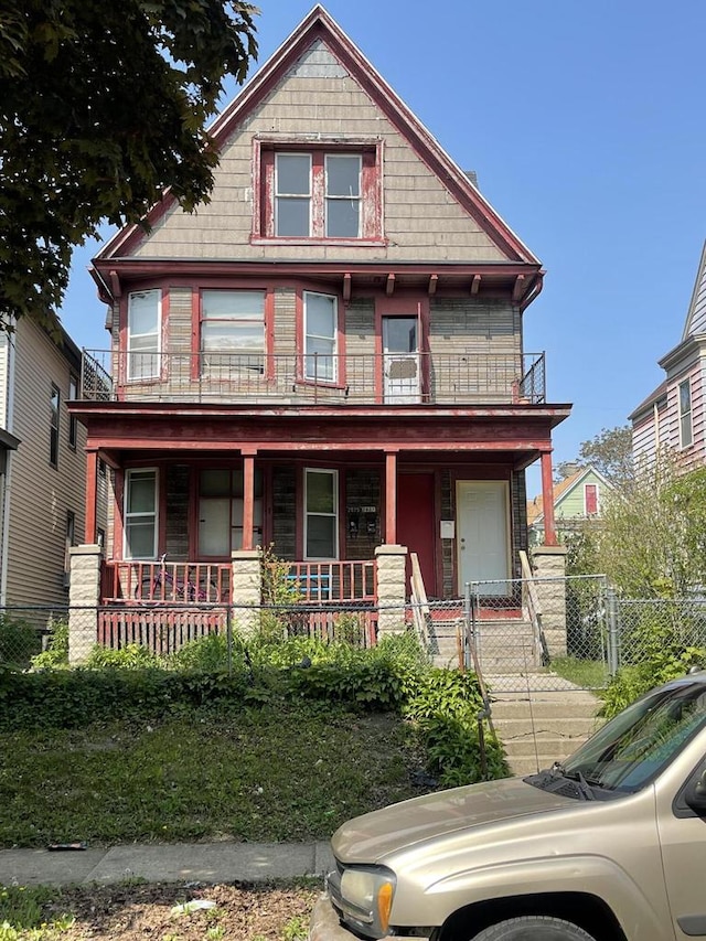 view of front of house with a balcony and covered porch