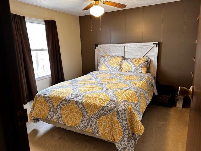 bedroom with ceiling fan and carpet