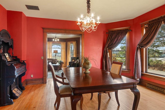 2730 Chestnut Dr, Plover, WI 54467 - dining space with a chandelier, light wood-style floors, and baseboards