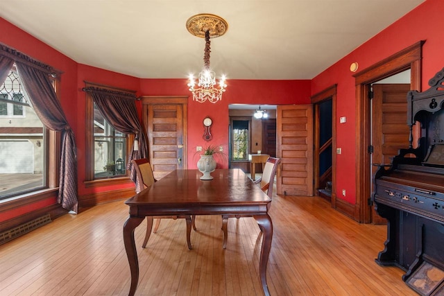 2730 Chestnut Dr, Plover, WI 54467 - dining space featuring a chandelier, plenty of natural light, and light wood finished floors