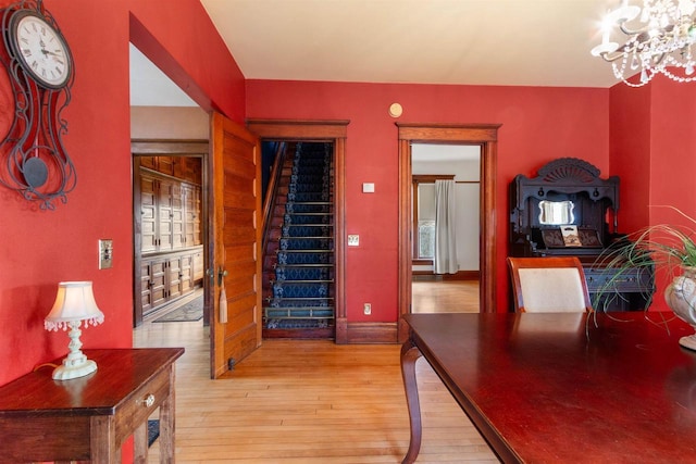 2730 Chestnut Dr, Plover, WI 54467 - dining room featuring light wood-type flooring, a chandelier, stairs, and baseboards