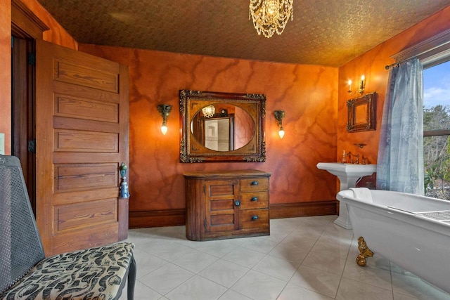 2730 Chestnut Dr, Plover, WI 54467 - bathroom with baseboards, a freestanding bath, and a chandelier