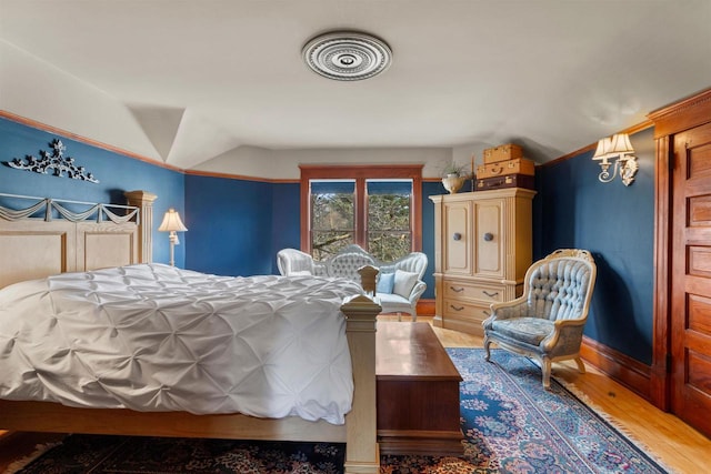 2730 Chestnut Dr, Plover, WI 54467 - bedroom with wood finished floors, vaulted ceiling, and baseboards