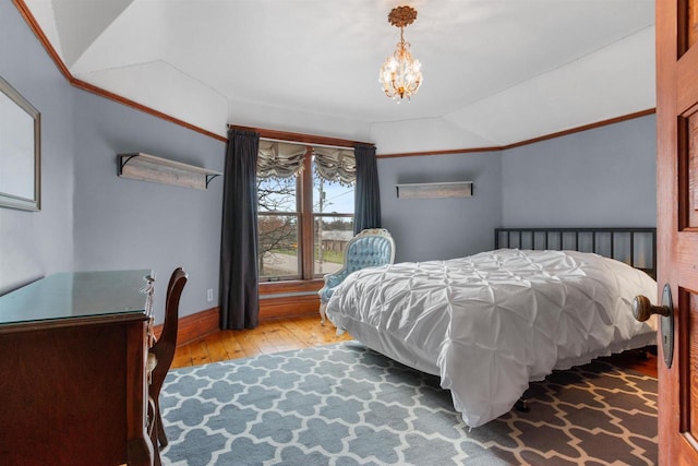2730 Chestnut Dr, Plover, WI 54467 - bedroom featuring hardwood / wood-style floors, vaulted ceiling, a chandelier, an office area, and baseboards