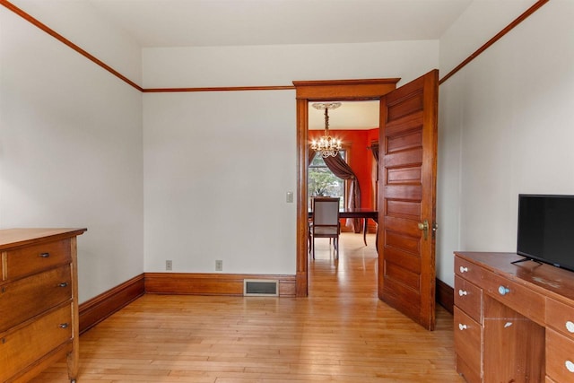 2730 Chestnut Dr, Plover, WI 54467 - unfurnished room featuring a chandelier, light wood finished floors, and baseboards