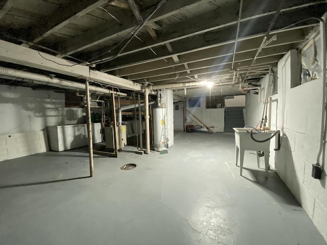 unfinished below grade area featuring water heater