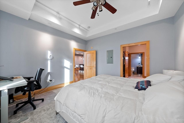 bedroom with rail lighting, a tray ceiling, ceiling fan, carpet floors, and electric panel