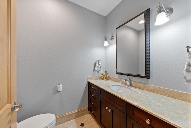 bathroom featuring tile patterned flooring, vanity, and toilet