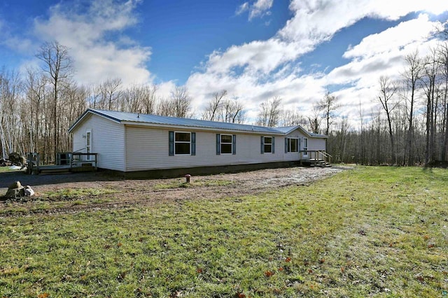 11242 S Pierce Rd, Solon Springs, WI 54873 - view of front of property featuring a front lawn and metal roof