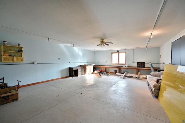 miscellaneous room with ceiling fan and concrete floors