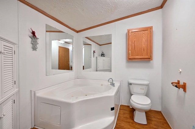 11242 S Pierce Rd, Solon Springs, WI 54873 - full bathroom with ornamental molding, a textured ceiling, wood finished floors, toilet, and a jetted tub