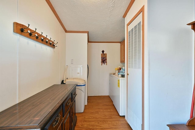 11242 S Pierce Rd, Solon Springs, WI 54873 - clothes washing area with light wood finished floors, a textured ceiling, a heating unit, ornamental molding, and cabinet space