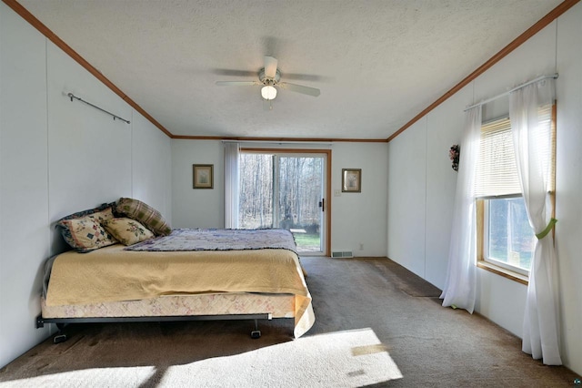 bedroom featuring access to outside, crown molding, carpet flooring, ceiling fan, and a textured ceiling