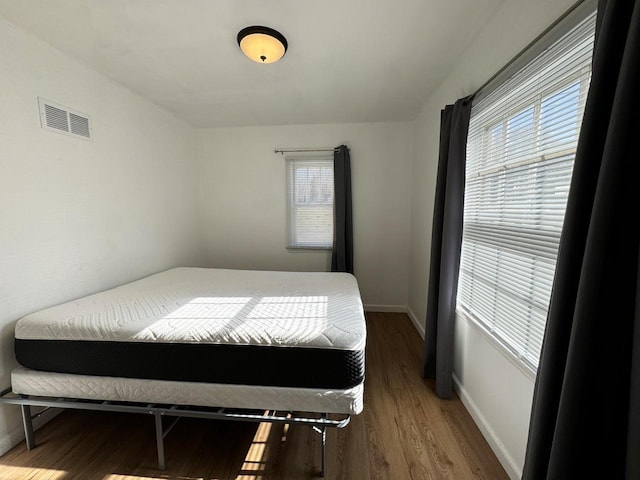 bedroom with hardwood / wood-style flooring