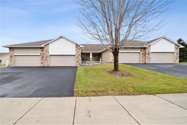 single story home with a front yard and a garage