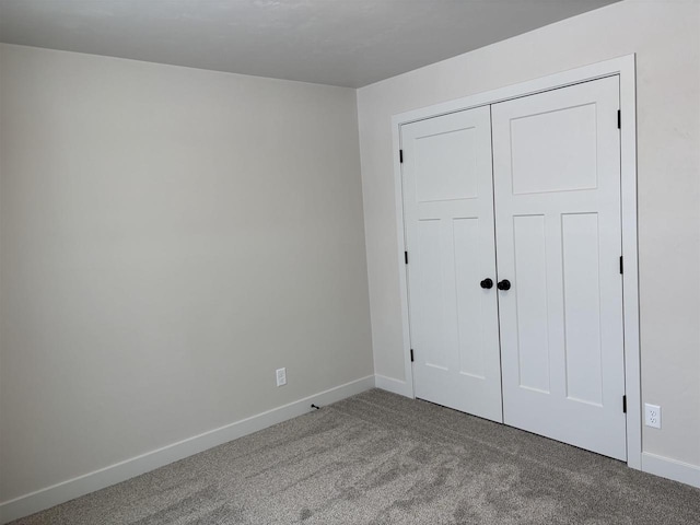 unfurnished bedroom featuring a closet and carpet