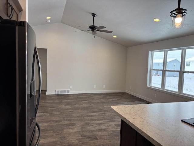 kitchen with black fridge, ceiling fan, lofted ceiling, and dark wood-type flooring