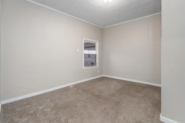 carpeted spare room with crown molding