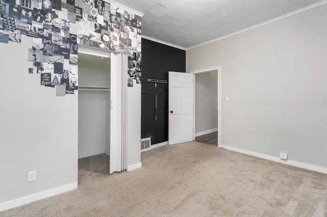 unfurnished bedroom with carpet, a closet, and crown molding