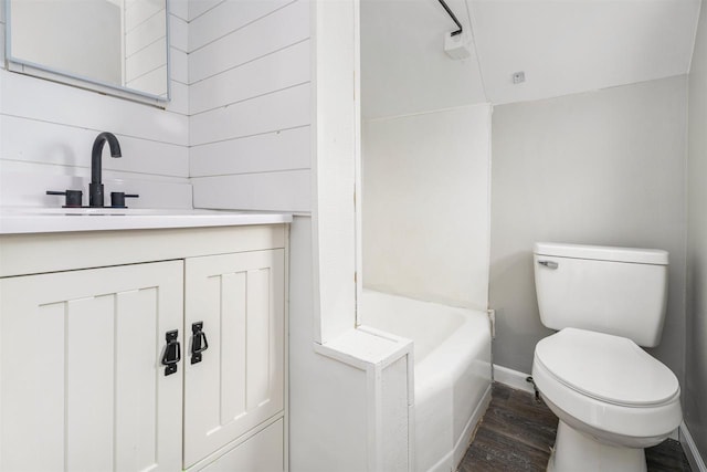 bathroom featuring wood-type flooring, vanity, and toilet