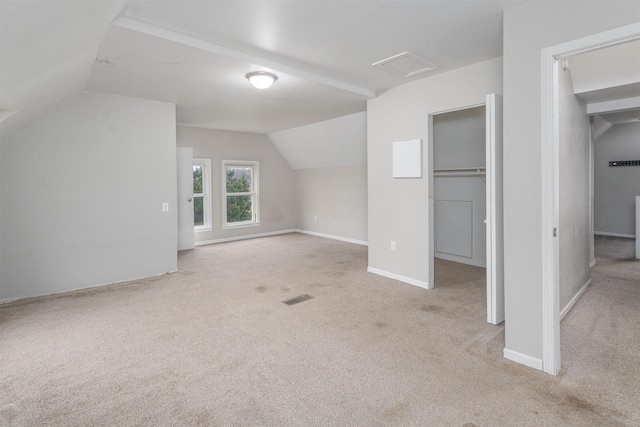 bonus room featuring light colored carpet and lofted ceiling