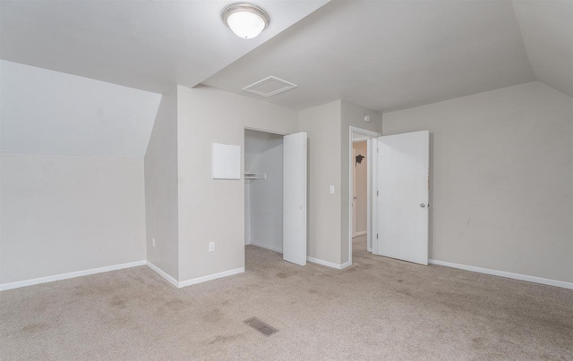 bonus room featuring light colored carpet and vaulted ceiling