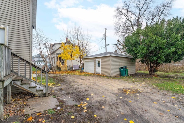 view of yard featuring an outbuilding and a garage