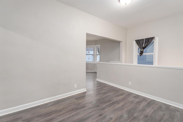 unfurnished room with dark hardwood / wood-style flooring