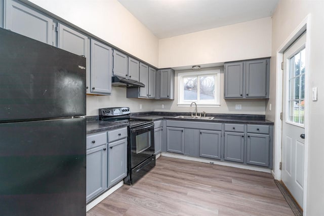 kitchen featuring sink, light hardwood / wood-style flooring, gray cabinetry, and black appliances