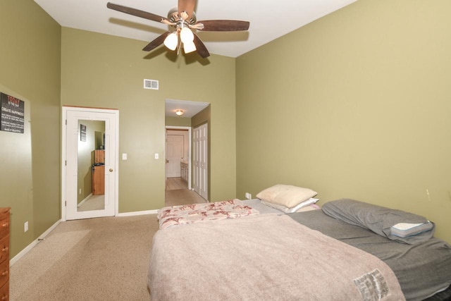 bedroom with light carpet, high vaulted ceiling, ceiling fan, connected bathroom, and a closet