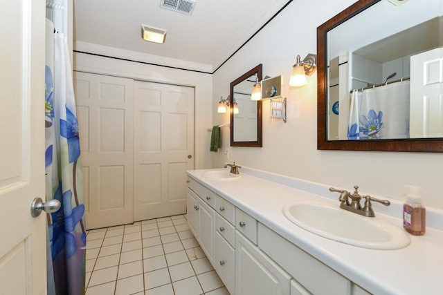 bathroom featuring tile patterned flooring, visible vents, a sink, and double vanity