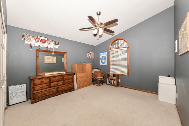 carpeted bedroom featuring baseboards, vaulted ceiling, and a ceiling fan