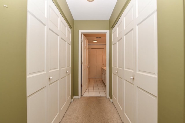 hall with light tile patterned flooring