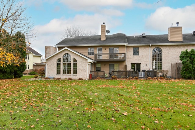 back of house with a balcony, a chimney, cooling unit, and a lawn