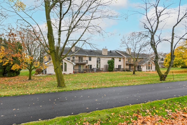 view of front of home with a front lawn and a chimney