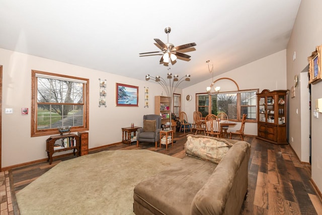 living room with ceiling fan with notable chandelier, lofted ceiling, baseboards, and wood finished floors